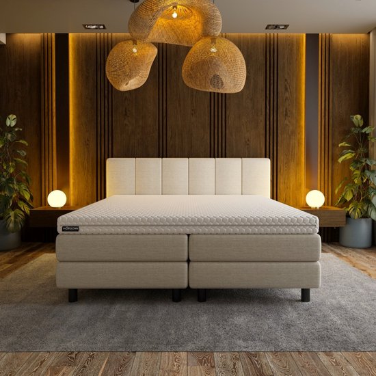 Luxe boxspring met Mörgenn topper, gestoffeerd hoofdbord en sfeervolle verlichting.