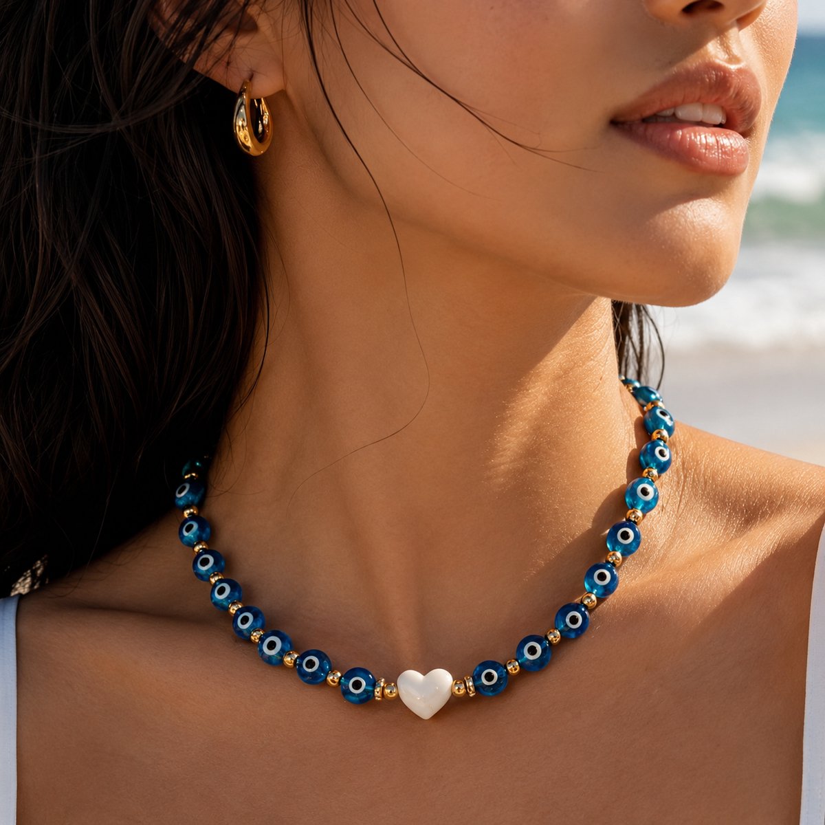 Luxamore® Kralenketting Blauw/Goud/Wit – Ketting voor Dames met Oogkralen en Witte Hartbedel