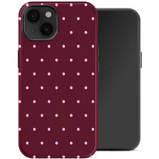 Coque bordeaux à pois roses, à côté d'un iPhone.