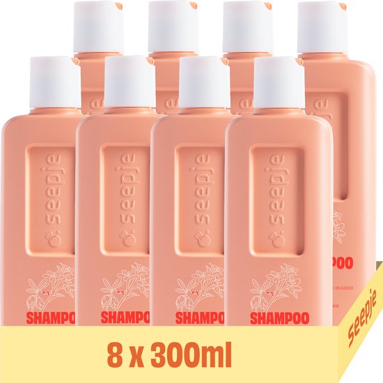 Voordeelverpakking van acht 300ml Seepje Hydrate & Nourish shampoo flessen in perzik kleur met botanische print.