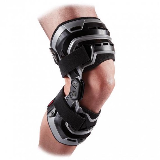 Grijze en zwarte kniebrace met klittenbandsluitingen op een gebogen knie.