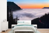 Behang - Fotobehang Een wolkengordijn in het Nationaal park Mount Rainier - Breedte 600 cm x hoogte 400 cm