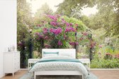 Behang - Fotobehang roze rozen groeien als planten in de wilde natuur - Breedte 450 cm x hoogte 300 cm