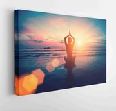 Canvas schilderij - Silhouette young woman practicing yoga on the beach at sunset. Meditation.  -     536256619 - 40*30 Horizontal