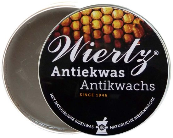 Zwarte blik met 'Wiertz Antiekwas' en afbeelding van honingraten. Deksel is open.
