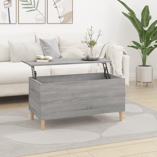 Grijze salontafel met houtnerf en opklapbaar blad, op houten pootjes.