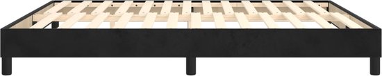 Een zwart boxspring frame met houten lattenbodem, staand op vier poten.
