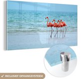MuchoWow® Glasschilderij 120x60 cm - Schilderij acrylglas - Vier flamingo's staan op het strand - Foto op glas - Schilderijen