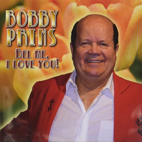 Bobby Prins in rood jasje en witte blouse, met oranje bloemen op de achtergrond. Titel: 'Bel Me, I Love You!'.