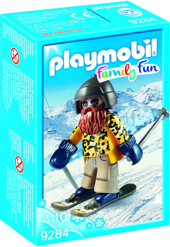 Playmobil skiër met baard, skibril, gele jas met luipaardprint, beige broek en blauwe wanten, op ski's.