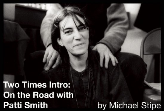 Patti Smith zit met haar handen op haar schoot, met een tekst overlay: 'Two Times Intro: On the Road with Patti Smith by Michael Stipe'.