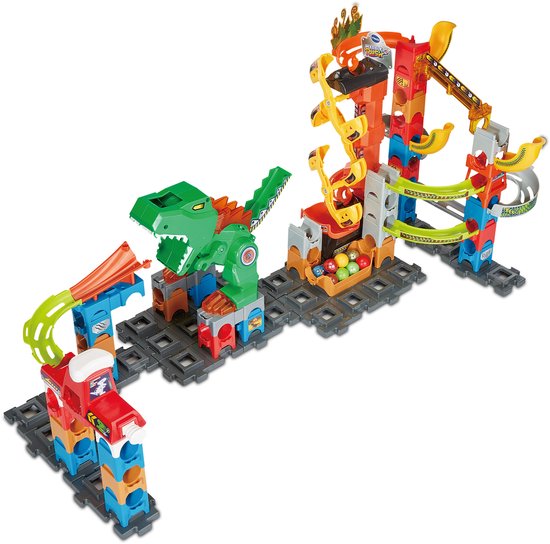 Knikkerbaan met groene dinosaurus, rode lanceerbaan, en bak met gekleurde knikkers.