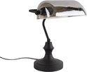 Lampe de banquier noire avec abat-jour gris semi-circulaire et ampoule visible.