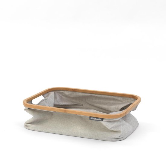 Grijze Brabantia wasmand met bamboe frame, opgevouwen.