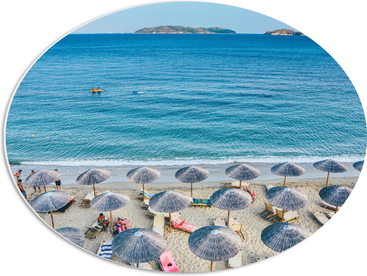 PVC Schuimplaat Ovaal - Rieten Parasols met Ligbedjes op het Strand - 56x42 cm Foto op Ovaal (Met Ophangsysteem)