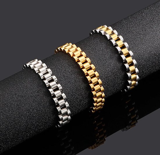 Drie schakelarmbanden: twee zilverkleurige en één goudkleurige, op een zwarte ondergrond.