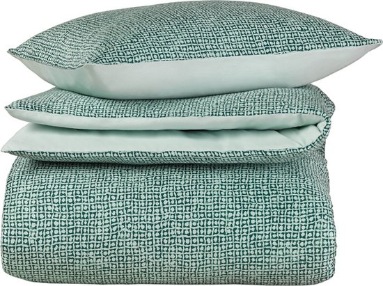 Taies d'oreiller et housse de couette empilées avec un motif abstrait vert.