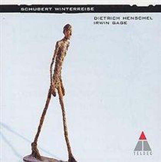 Een mager, bronzen beeld van een lopende man met de tekst 'Schubert Winterreise' en namen van artiesten.