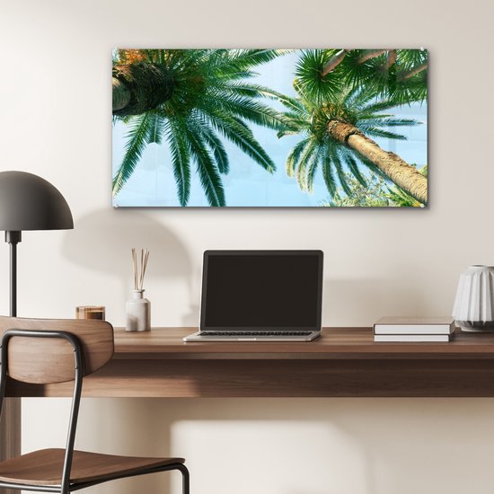 MuchoWow® Glasschilderij 80x40 cm - Schilderij acrylglas - Palmbladeren - Lucht - Zomer - Tropisch - Foto op glas - Schilderijen