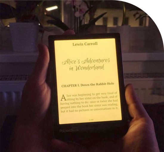 Iemand houdt de verlichte PocketBook Verse Pro e-reader vast, waarop Alice's Adventures in Wonderland wordt weergegeven.