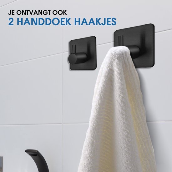 Twee zwarte, zelfklevende handdoekhaakjes aan een betegelde muur, één met een witte handdoek eraan.