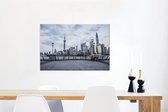 Canvas Schilderij Het Aziatische Shanghai gezien vanaf de Bund in China - 90x60 cm - Wanddecoratie