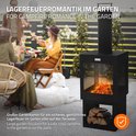Gezellige tuin scène met een zwarte tuinhaard, met brandend vuur, houtopslag en mensen die genieten aan een tafel.