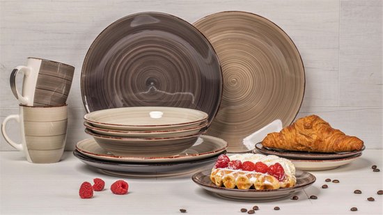 Servies in grijs en bruin met mokken, kommen en borden, met croissant en wafel.