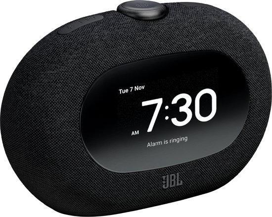 Zwarte JBL wekkerradio met een ovaal scherm waarop "Tue 7 Nov" en "7:30 AM" staat.