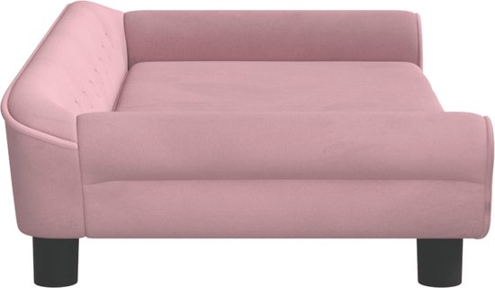 Canapé pour chien en velours rose avec boutons sur le côté, sur pieds ronds.
