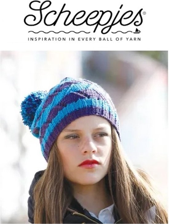 Fille aux longs cheveux bruns portant un bonnet rayé bleu et violet avec pompon.