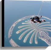 Canvas - Parachutespringer boven de Palm van Dubai - 40x40 cm Foto op Canvas Schilderij (Wanddecoratie op Canvas)
