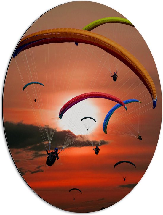 Dibond Ovaal - Grote Groep Paragliders tijdens Roodkleurige Zonsondergang - 51x68 cm Foto op Ovaal (Met Ophangsysteem)