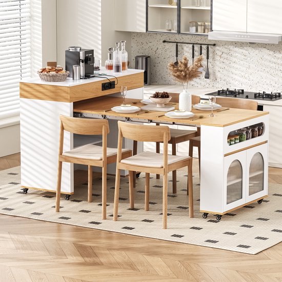 Îlot de cuisine extensible avec table à manger dans une cuisine, avec chaises et vaisselle.