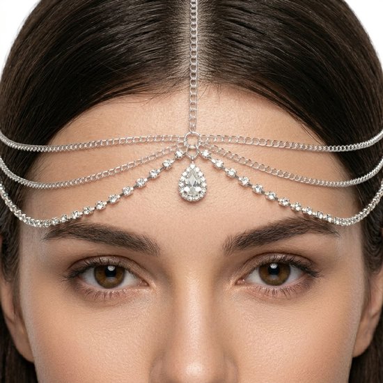Gros plan d'un bijou de cheveux argenté avec pendentif goutte et strass.
