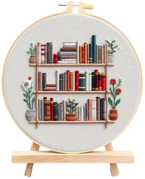 Borduurring met een geborduurde boekenplank vol boeken en plantjes, op een houten ezel, geïsoleerd op wit.