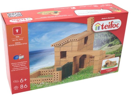 Doos van Teifoc bouwstenen, toont een Spaans huis met schoorsteen en tuin.