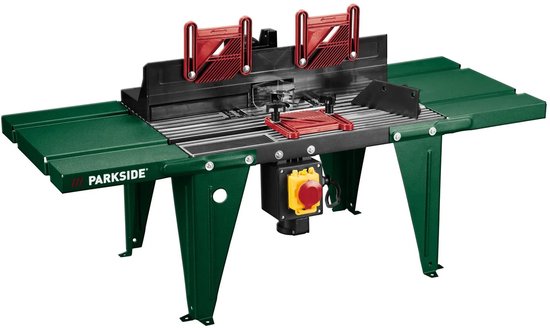 Parkside bovenfreesmachine met groene tafel, rode klemmen en zwarte geleider.