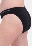 Close-up van een zwarte slip met logo op de tailleband.