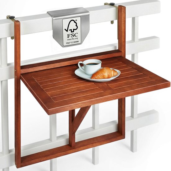 Bruine houten klaptafel met kopje koffie en croissant, bevestigd aan een witte reling.