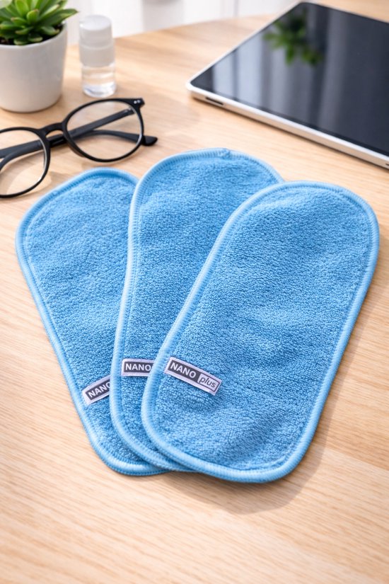 Drie blauwe NanoPlus doekjes liggen op een houten tafel.