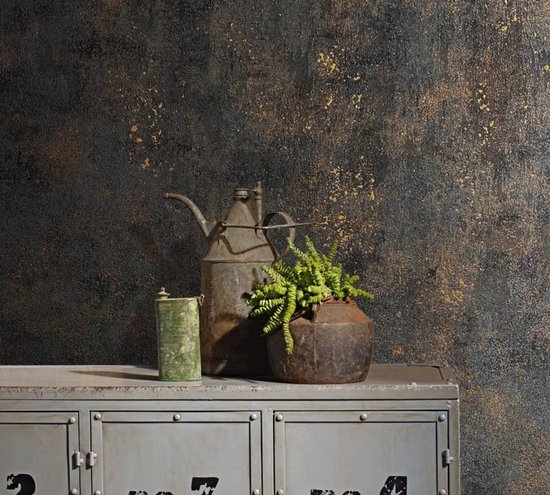 Betonlook behang met gouden spetters op een donkergrijze ondergrond, met op de voorgrond een metalen kast met decoratieve voorwerpen.