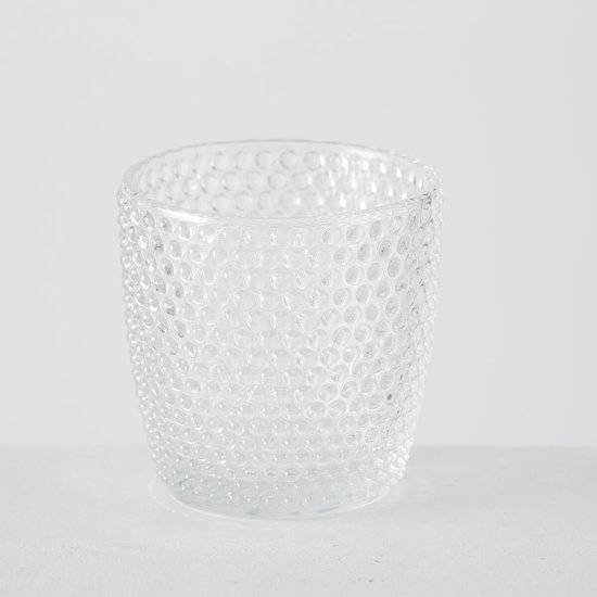 Glazen waxinelichthouder met een bolpatroon.