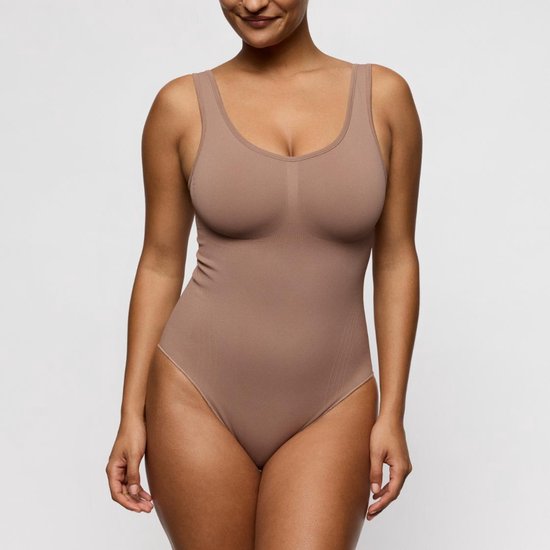 Damesmodel van voren, draagt een beige body met ronde halslijn en brede bandjes. Glad materiaal met subtiele lijnen.