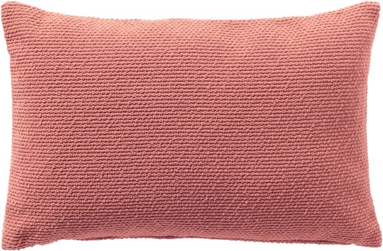 Coussin décoratif rose poudré de 40x60 cm avec une texture fine.