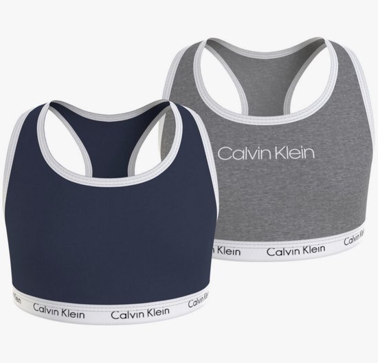 Twee Calvin Klein bralettes: één donkerblauw, één grijs. Beide met contrasterende witte bies en logo op de band.