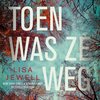 Boekcover 'Toen was ze weg' van Lisa Jewell, met een herfstbos en de titel in grote letters.