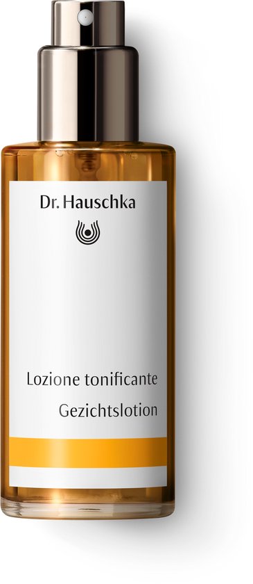 Dr. Hauschka Gezichtslotion in een glazen fles met sproeidop. De lotion is goudkleurig.