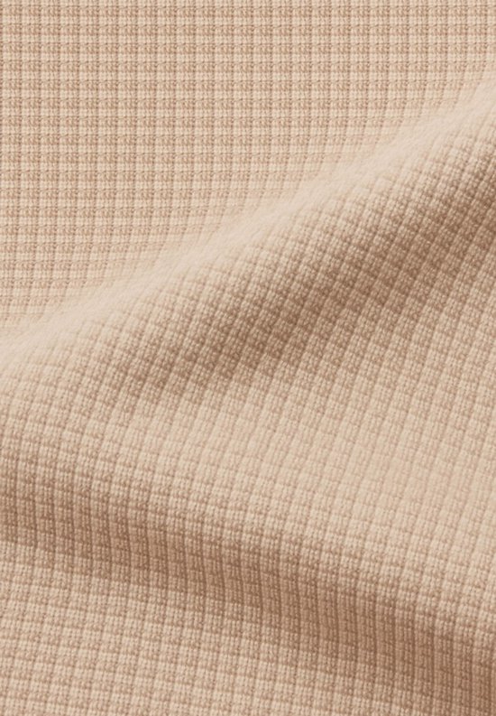 Beige stof met wafeltextuur van een Gorilla Wear trainingsjack.