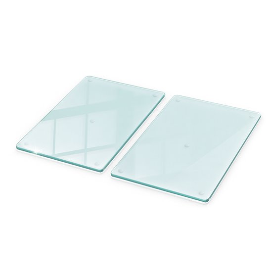 Deux planches à découper en verre transparentes disposées en diagonale, montrant les bords.